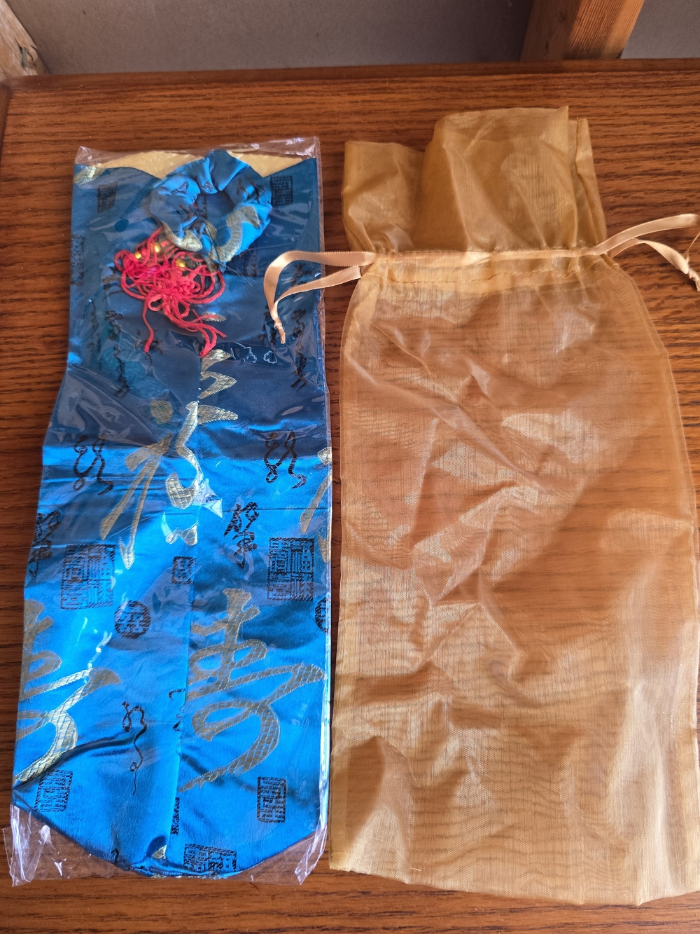 Blue Satin Gift Bag with Gold Accents and Red Tassel